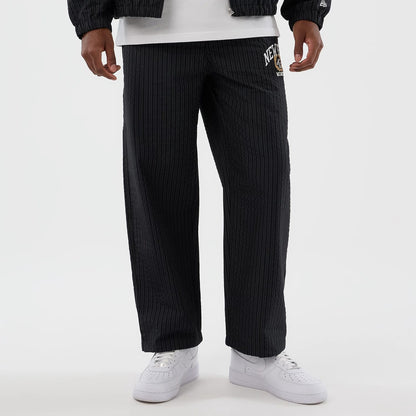 The model is wearing these New Era Street Class straight leg joggers in navy. 8