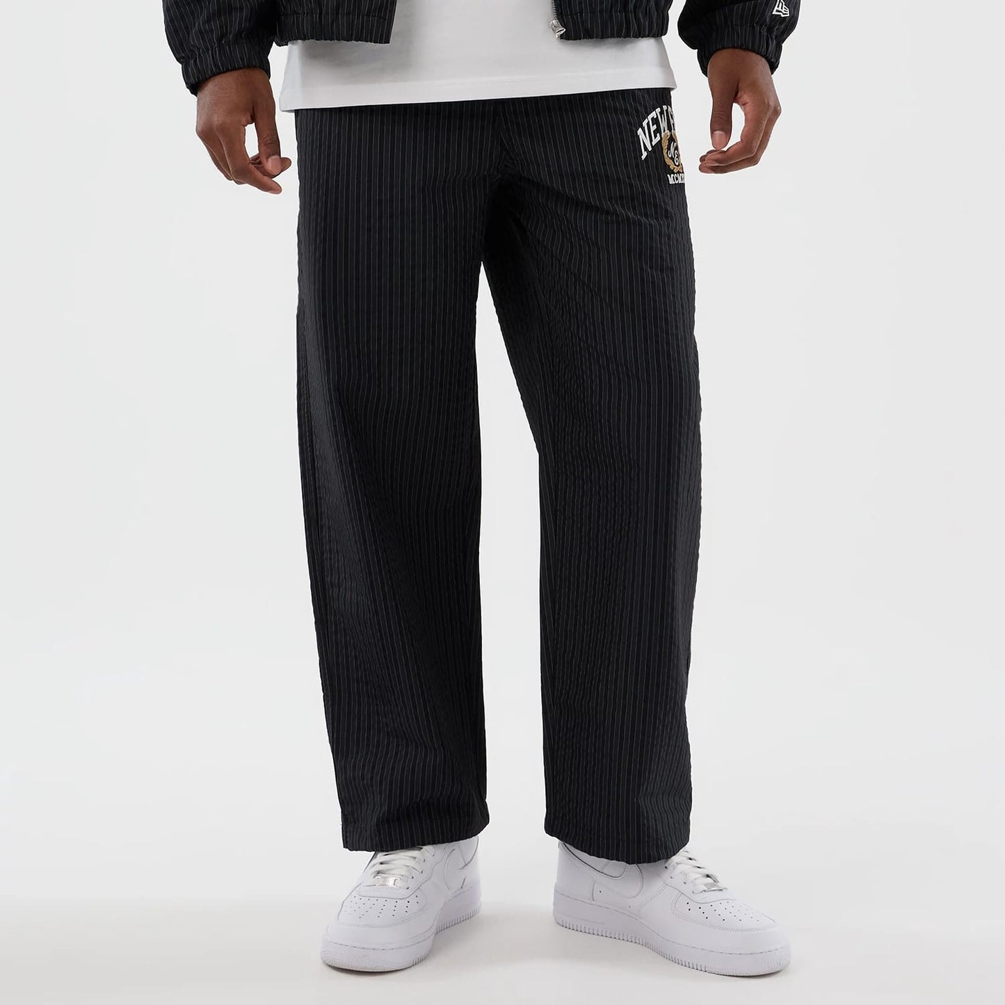 The model is wearing these New Era Street Class straight leg joggers in navy. 8