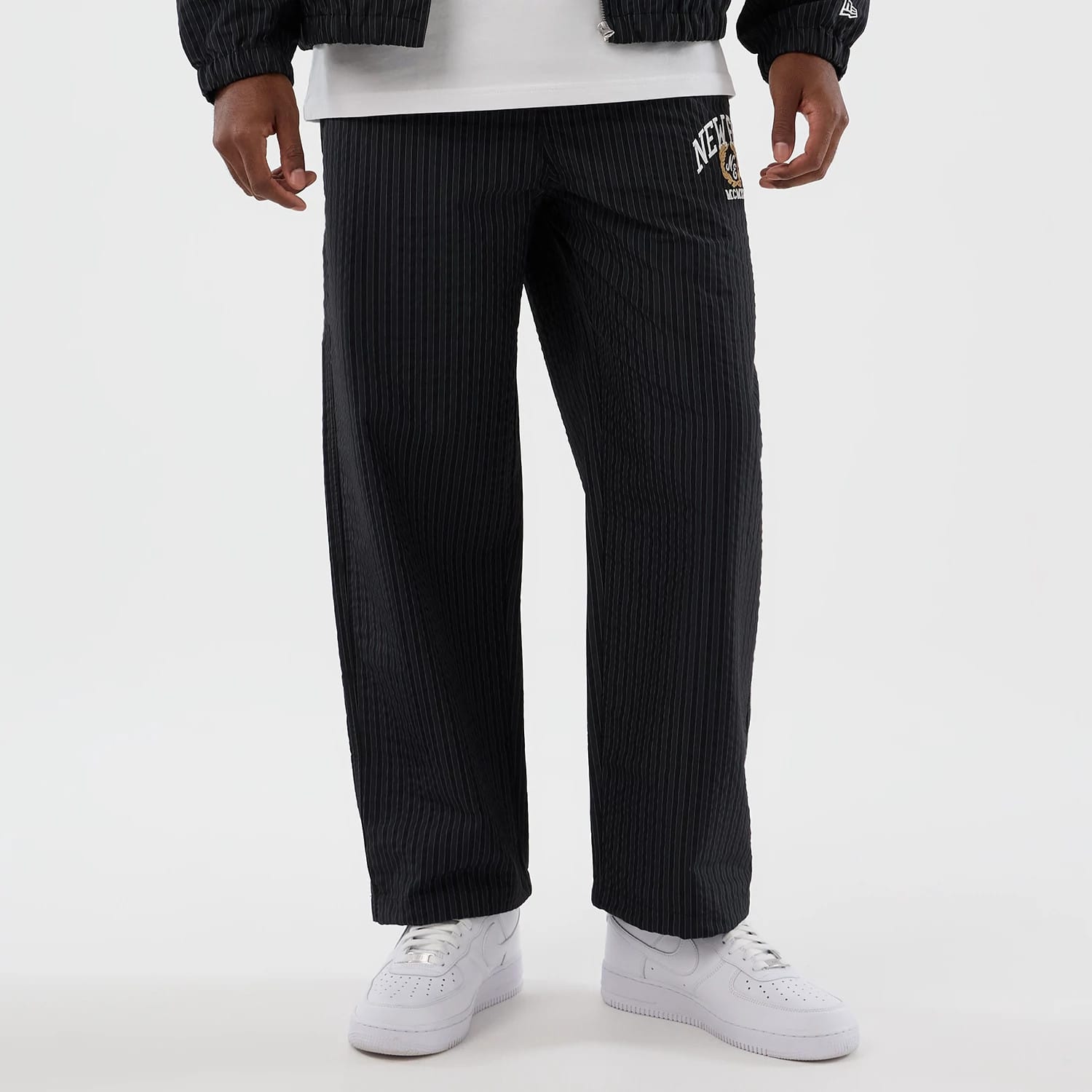 The model is wearing these New Era Street Class straight leg joggers in navy. 8