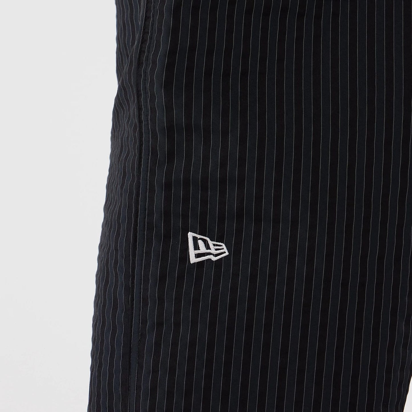 The model is wearing these New Era Street Class straight leg joggers in navy. 3