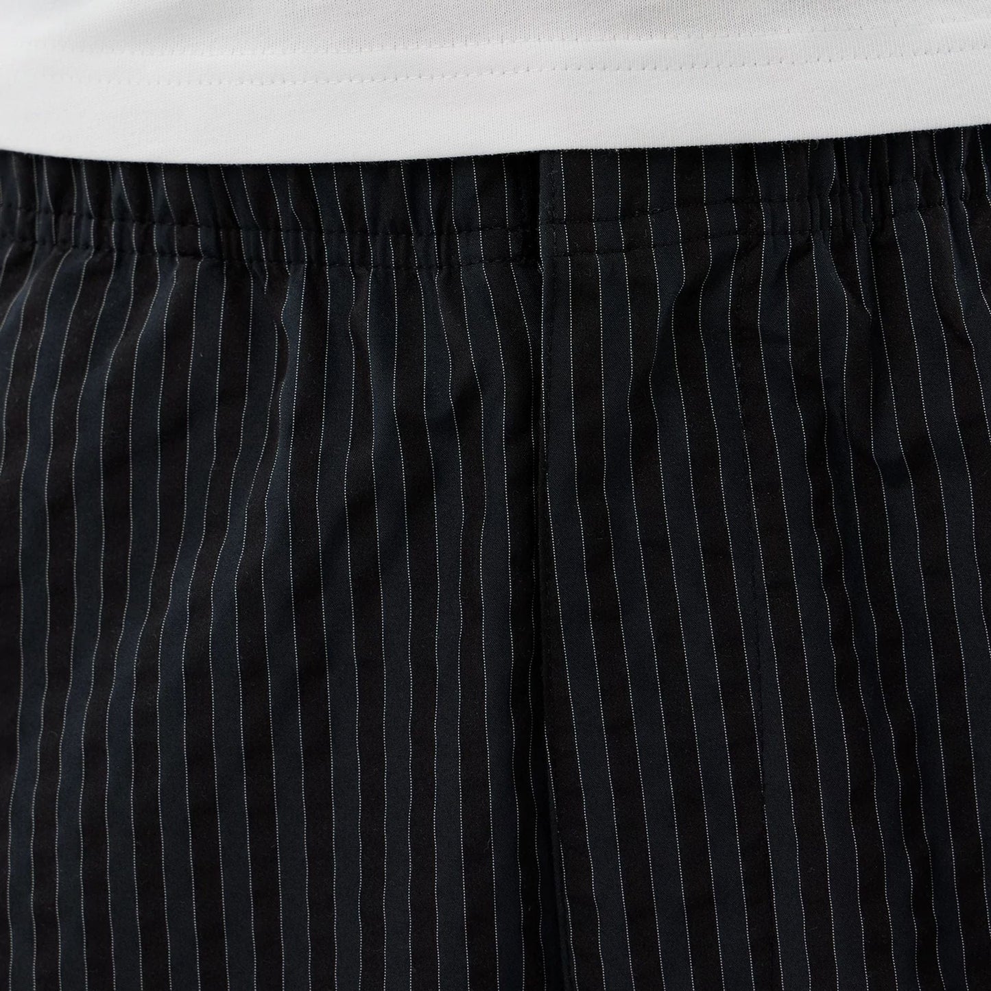 The model is wearing these New Era Street Class straight leg joggers in navy. 4