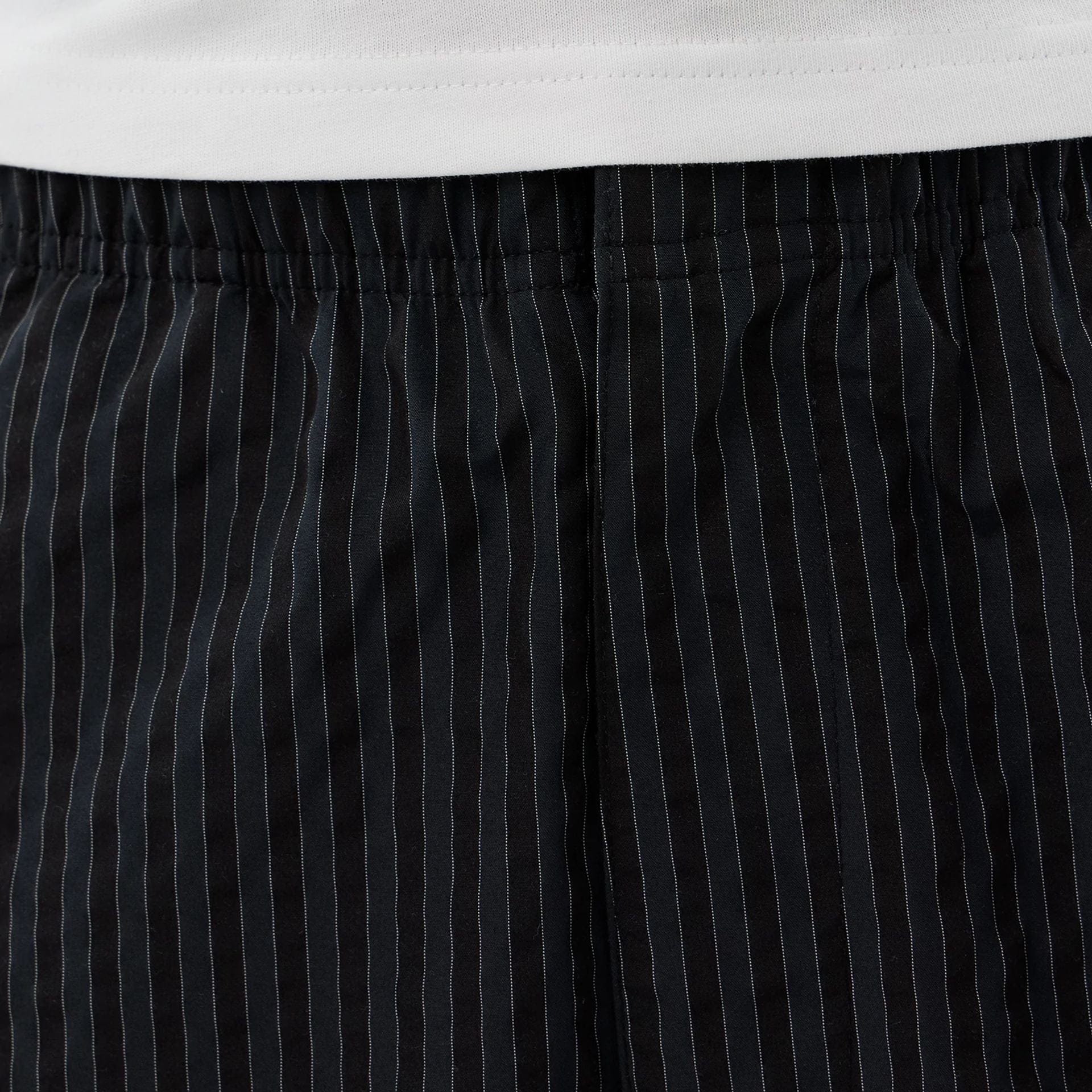 The model is wearing these New Era Street Class straight leg joggers in navy. 4