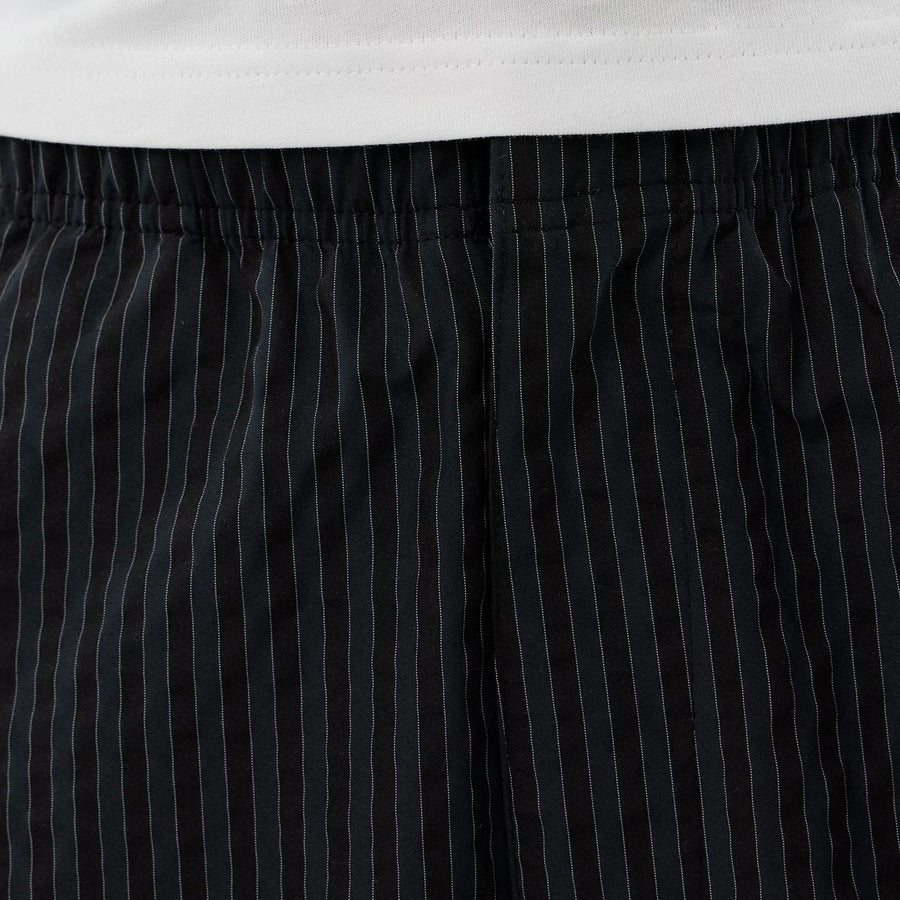 The model is wearing these New Era Street Class straight leg joggers in navy. 4