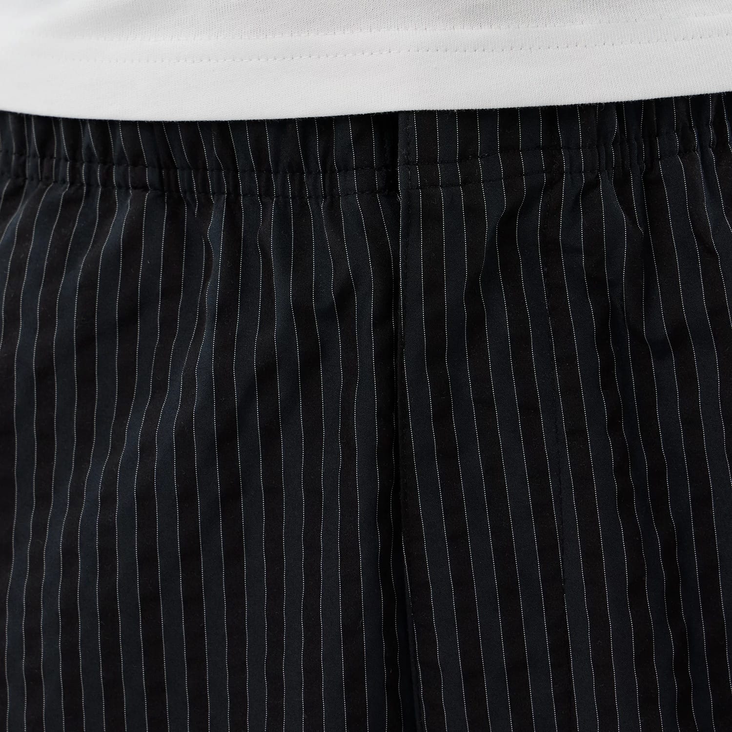 The model is wearing these New Era Street Class straight leg joggers in navy. 4