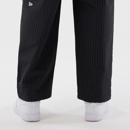 The model is wearing these New Era Street Class straight leg joggers in navy. 5
