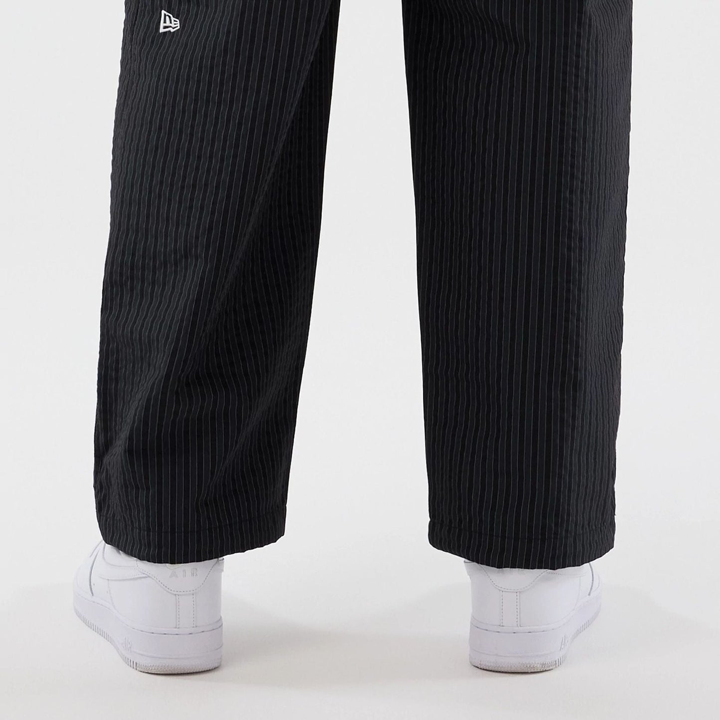The model is wearing these New Era Street Class straight leg joggers in navy. 5