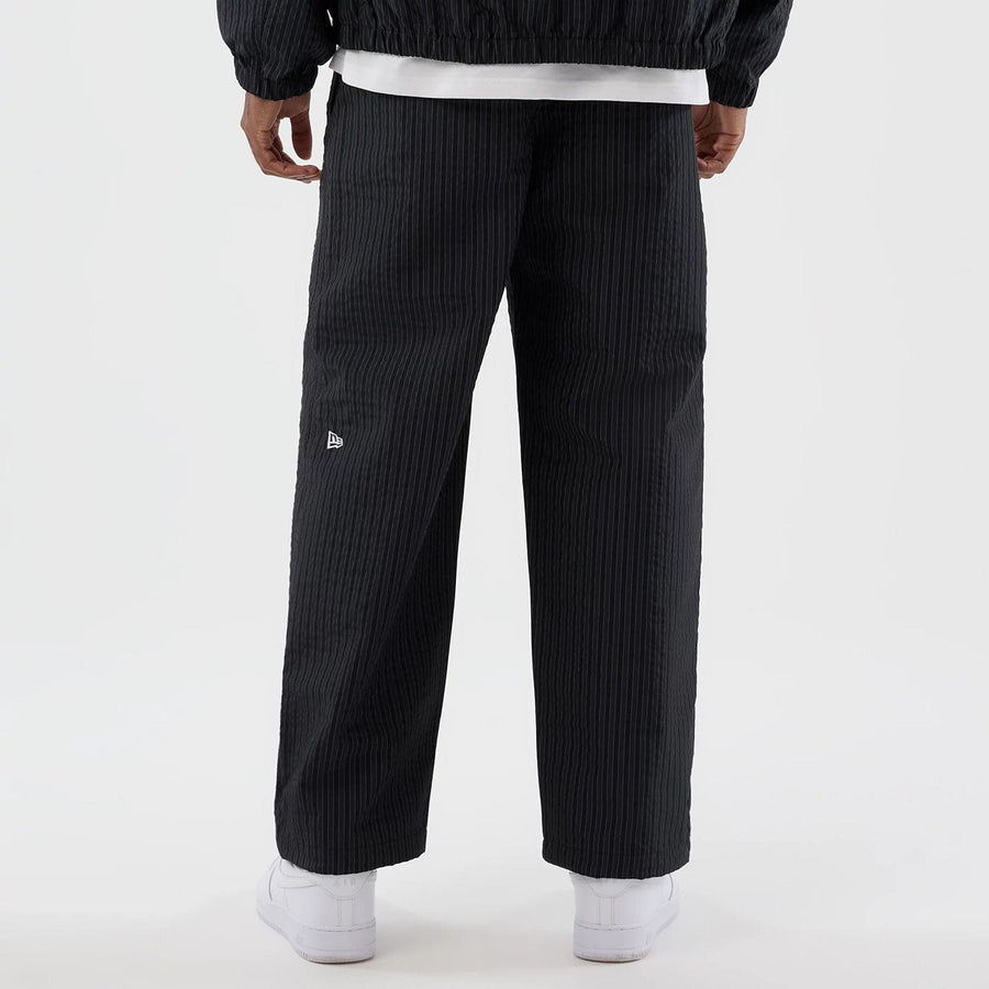 The model is wearing these New Era Street Class straight leg joggers in navy. 6