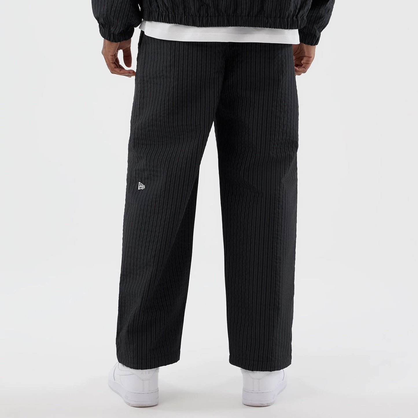 The model is wearing these New Era Street Class straight leg joggers in navy. 6