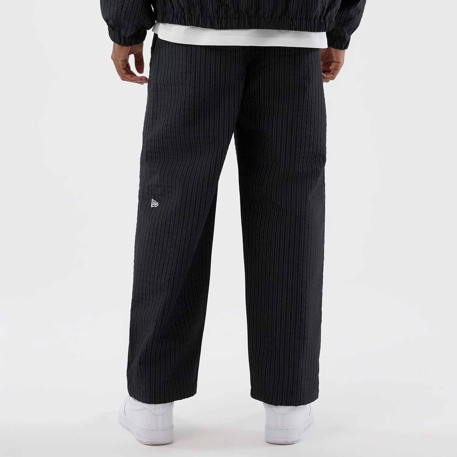 The model is wearing these New Era Street Class straight leg joggers in navy. 6
