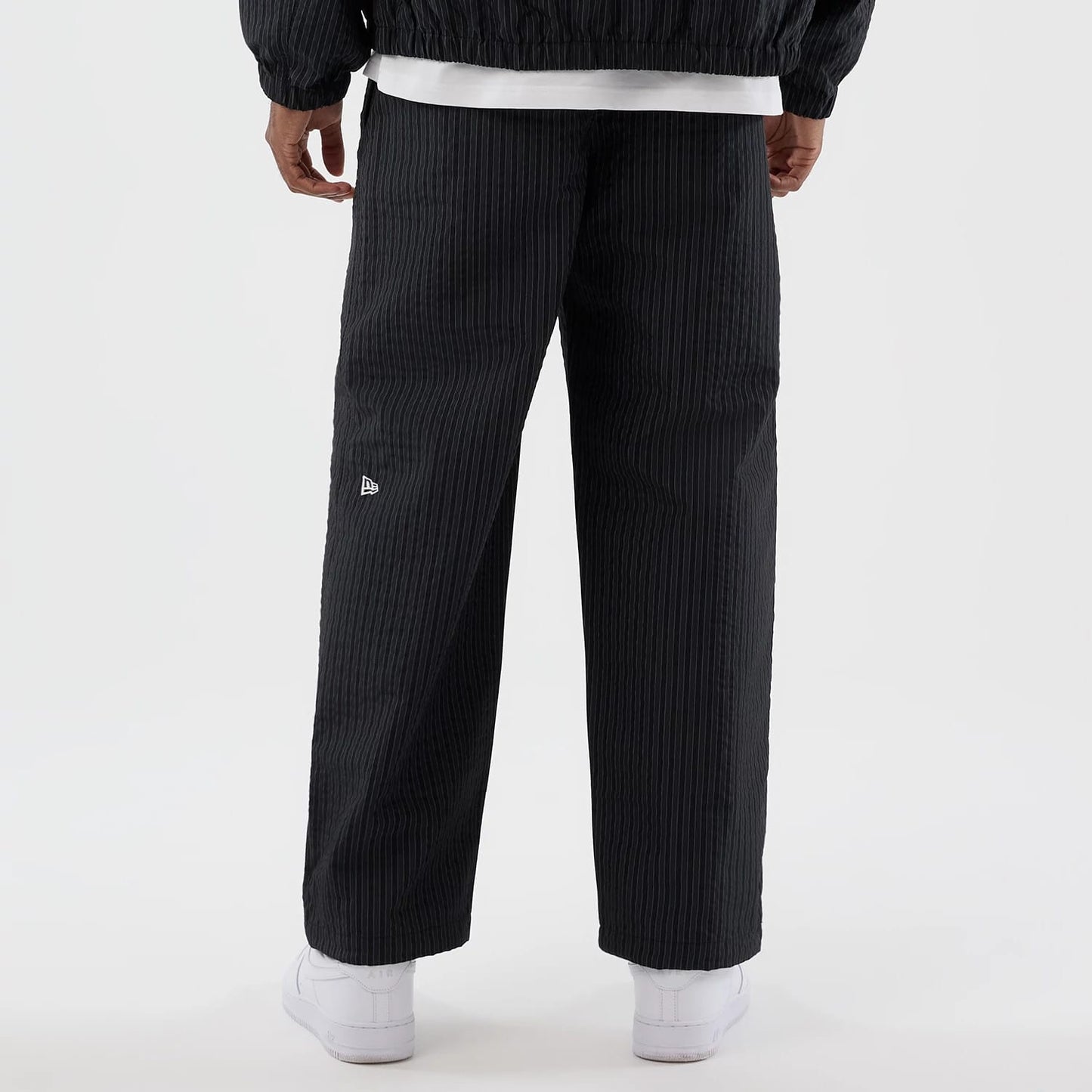 The model is wearing these New Era Street Class straight leg joggers in navy. 6