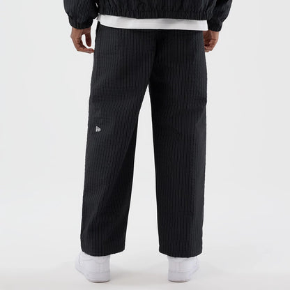 The model is wearing these New Era Street Class straight leg joggers in navy. 6