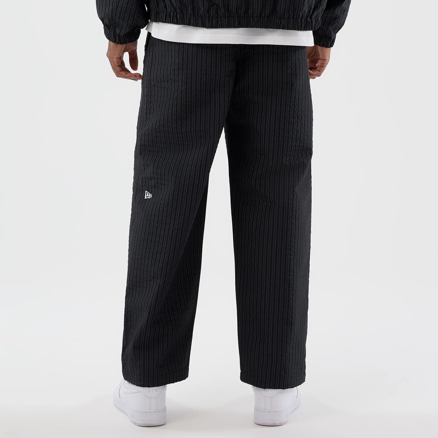 The model is wearing these New Era Street Class straight leg joggers in navy. 6