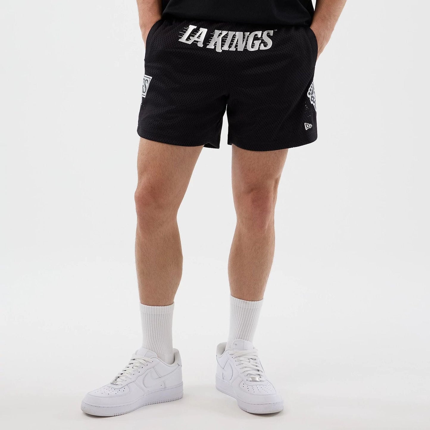 The Male model is wearing LA Kings NHL Street Culture Black Oversized Shorts  1