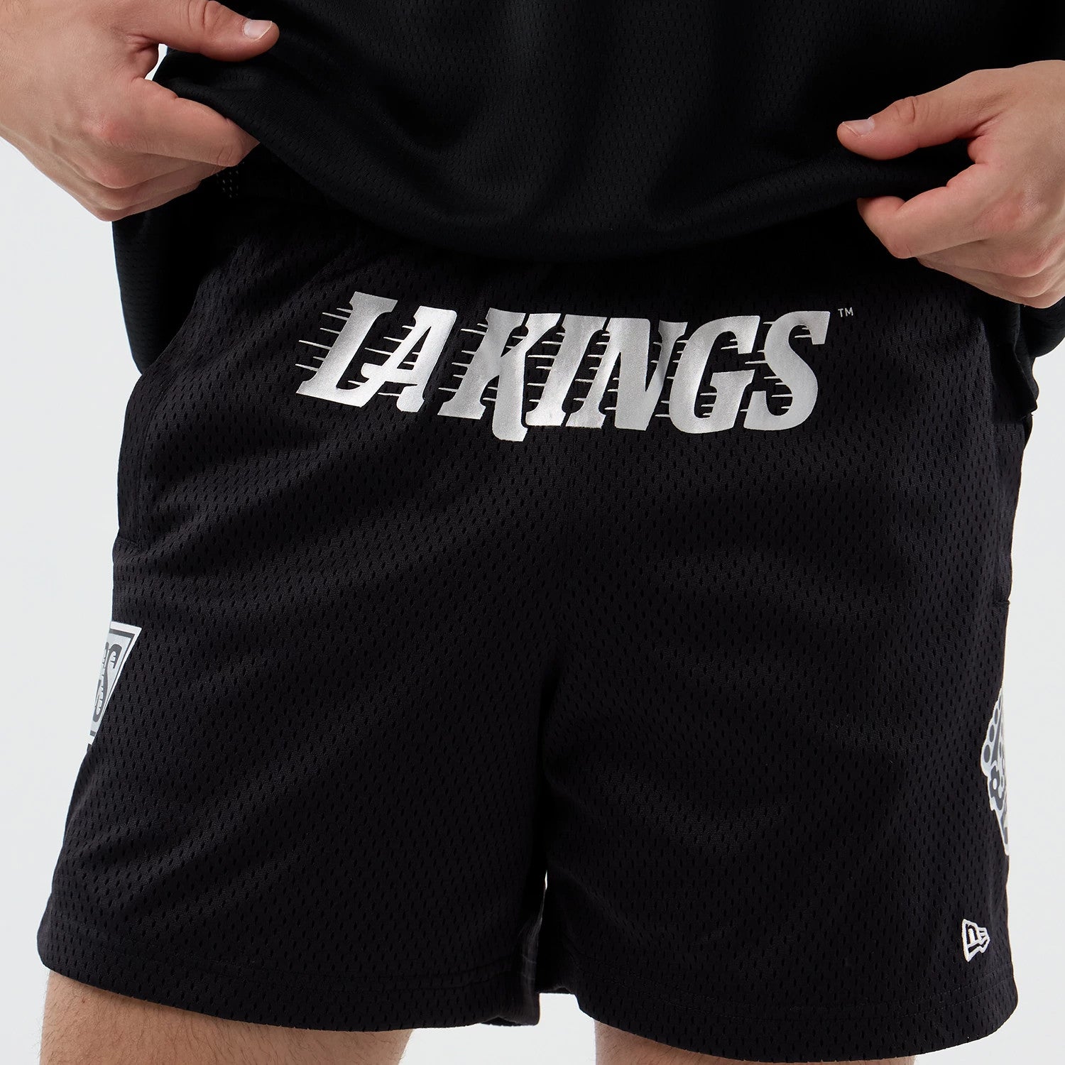 The Male model is wearing LA Kings NHL Street Culture Black Oversized Shorts 5