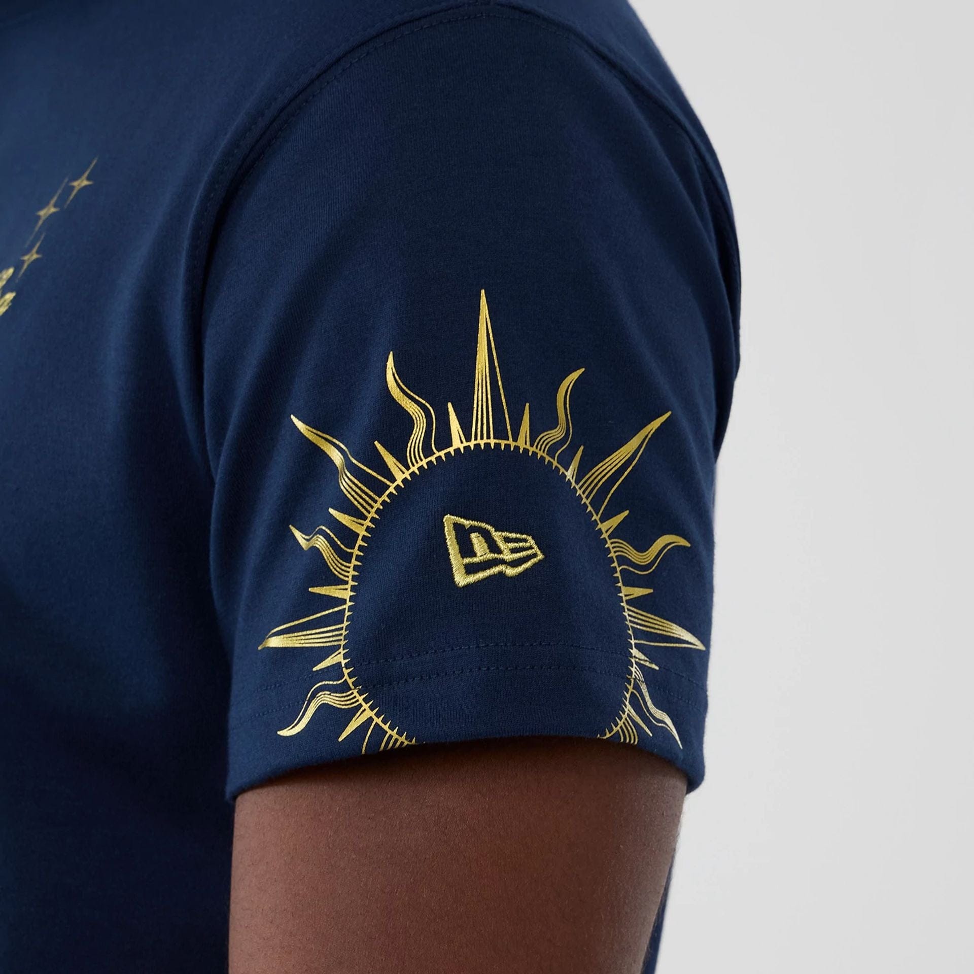 The model is wearing this New Era Cosmic Craft T-Shirt in blue. 4