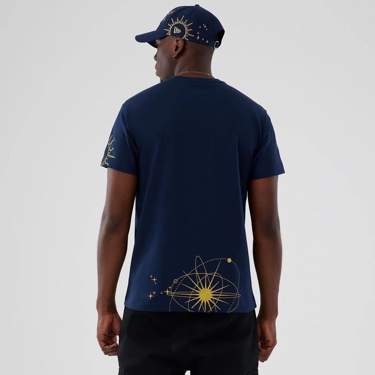 The model is wearing this New Era Cosmic Craft T-Shirt in blue. 2