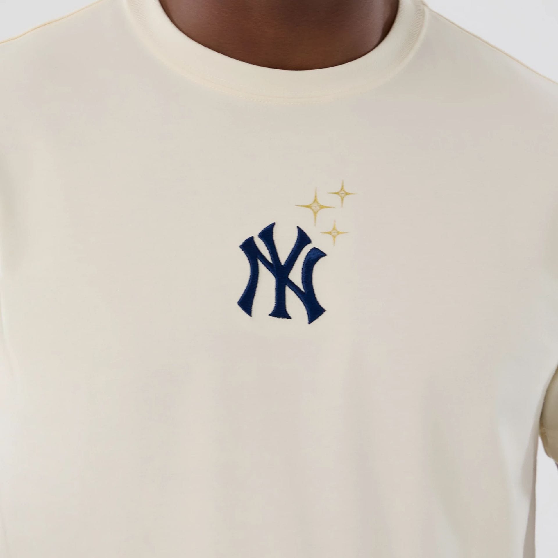 The model is wearing this MLB Cosmic Craft New York Yankees T-Shirt in white. 3
