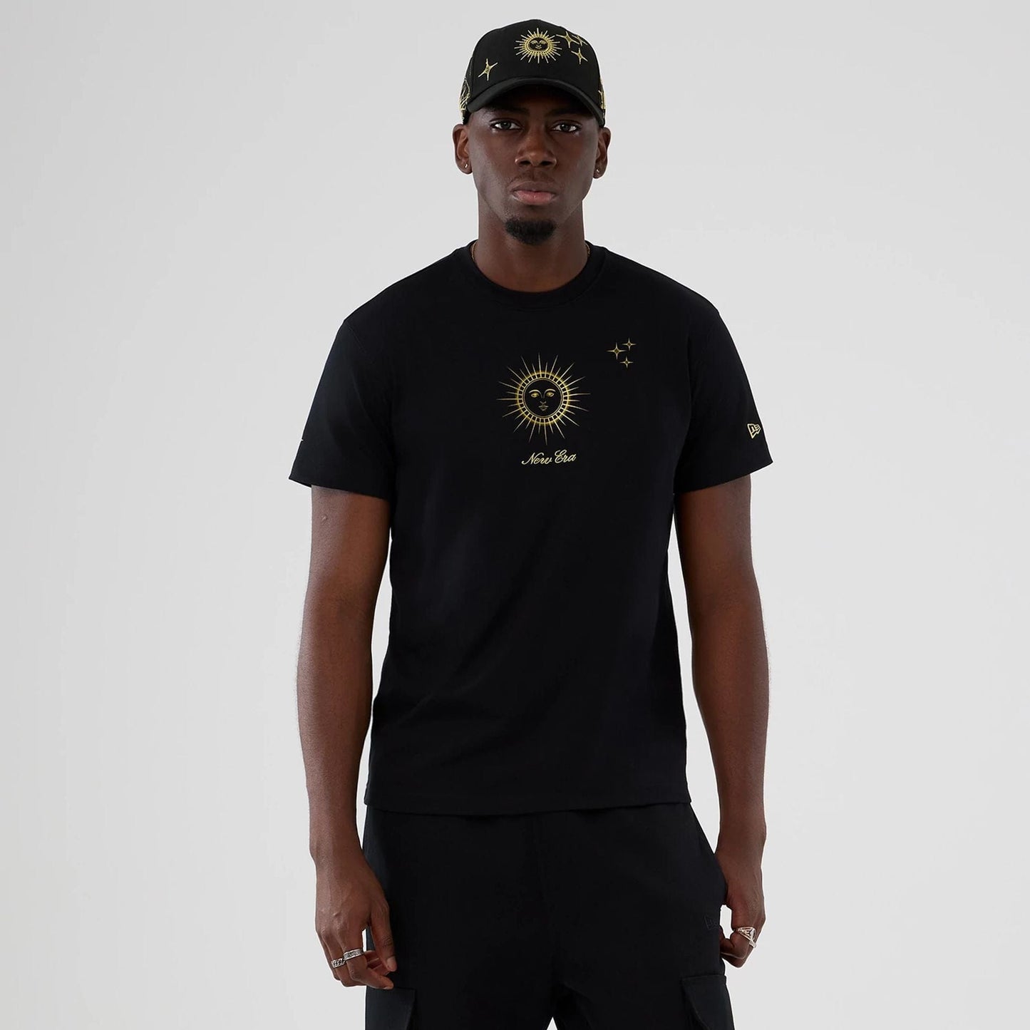 The model is wearing this New Era Cosmic Craft T-Shirt in black. 1