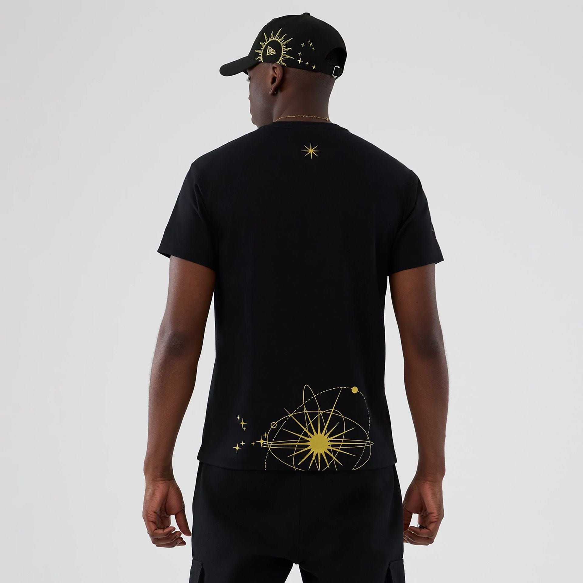 The model is wearing this New Era Cosmic Craft T-Shirt in black. 2