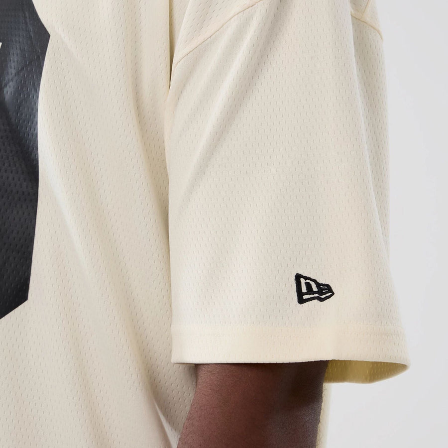 The model is wearing this NFL Historic Las Vegas Raiders Oversized T-Shirt in cream. 5