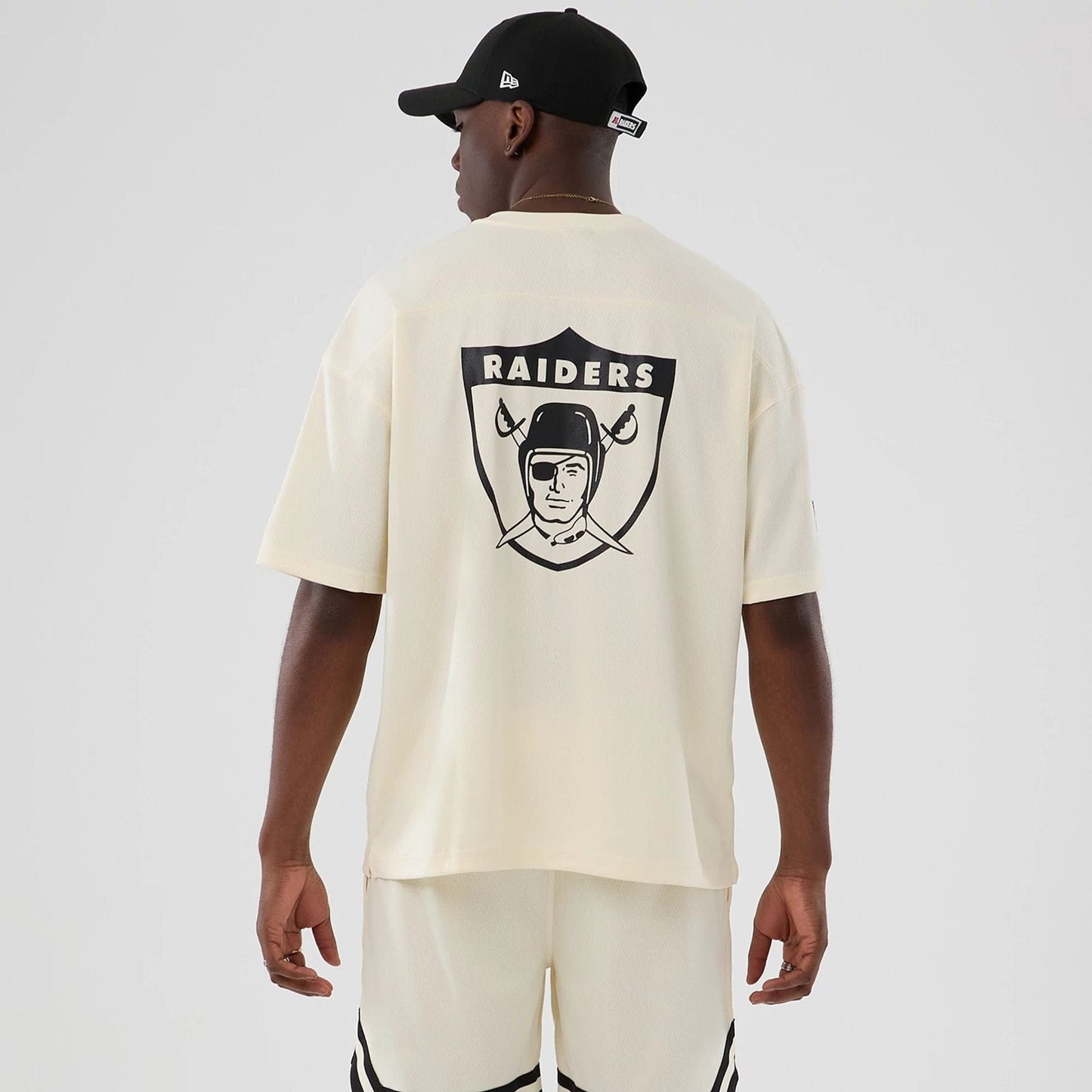 The model is wearing this NFL Historic Las Vegas Raiders Oversized T-Shirt in cream. 2