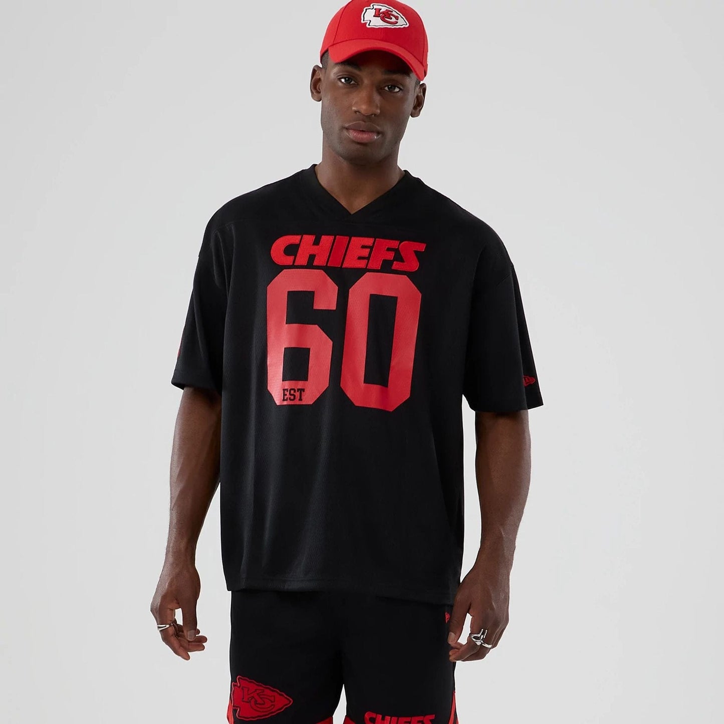 The model is wearing this NFL Historic Kansas City Chiefs Oversized T-Shirt in black. 1