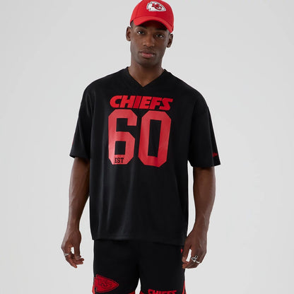 The model is wearing this NFL Historic Kansas City Chiefs Oversized T-Shirt in black. 1