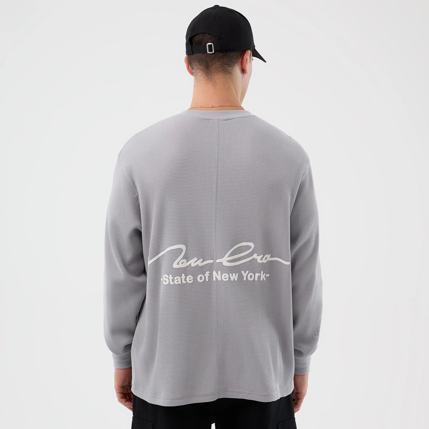 The Male model is wearing New Era Basic Grey Long Sleeve T-Shirt 2