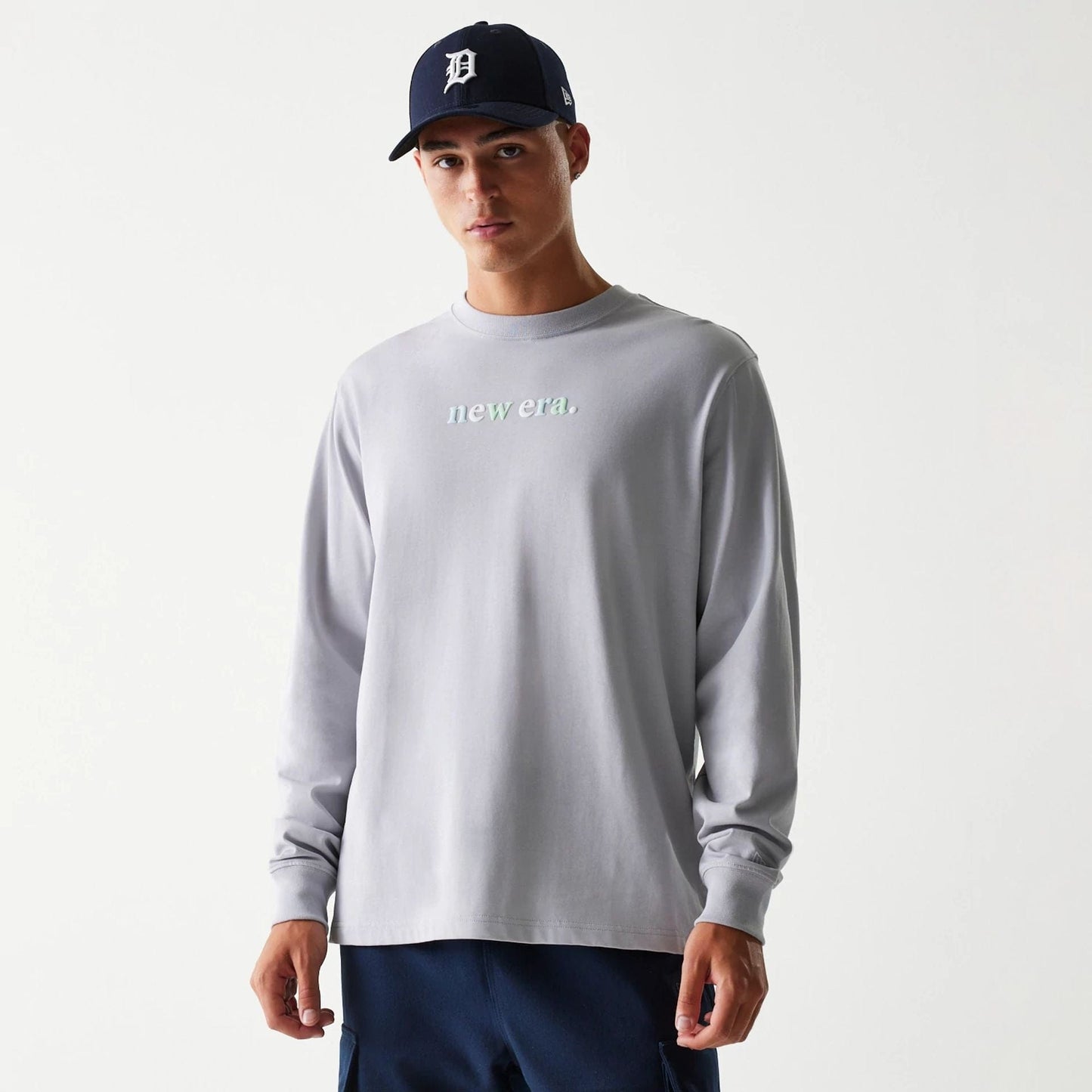 The Male model is wearing New Era 90s Vibe Grey Long Sleeve T-Shirt 1