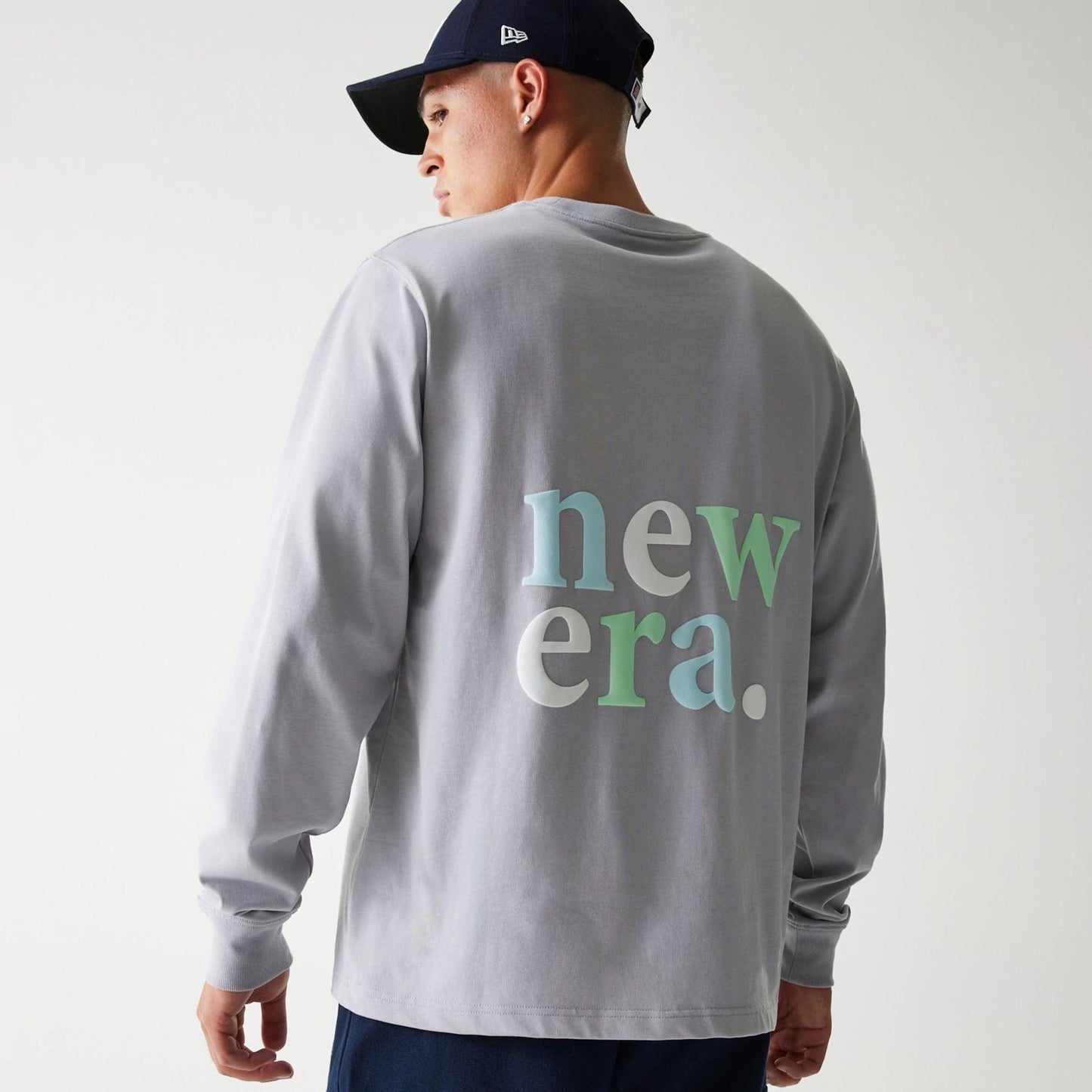 The Male model is wearing New Era 90s Vibe Grey Long Sleeve T-Shirt 2