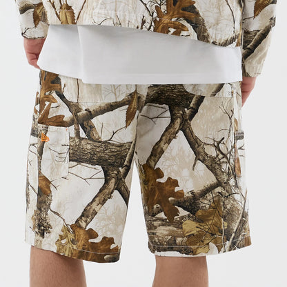 The Male model is wearing  New Era Earthy Skin Real Tree Snow Oversized Shorts 6