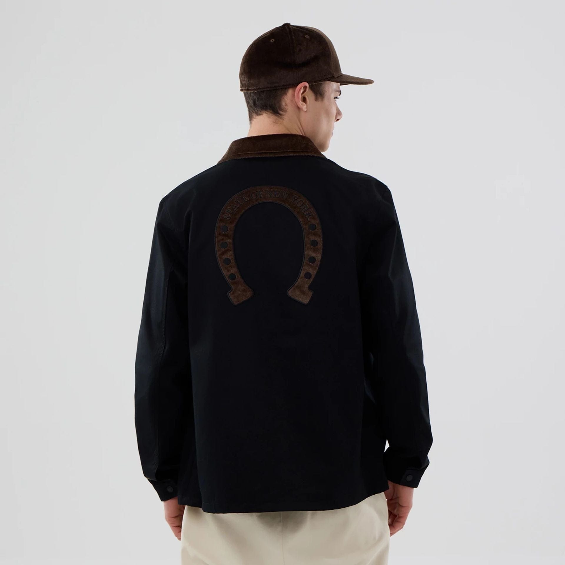 The model is wearing this New Era Year Of The Horse Jacket in black. 2