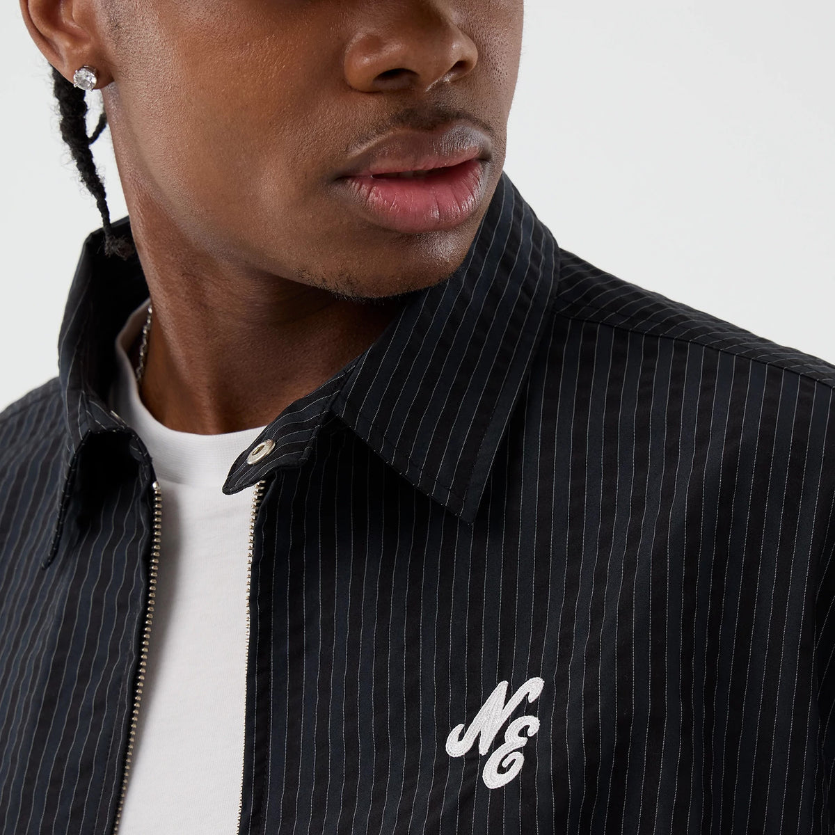 The model is wearing this New Era Street Class jacket in navy. 4