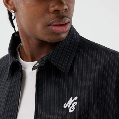 The model is wearing this New Era Street Class jacket in navy. 4