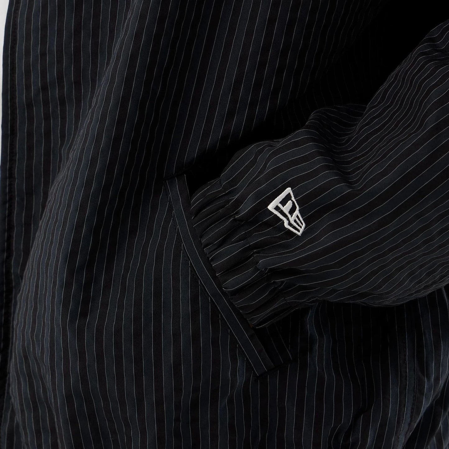 The model is wearing this New Era Street Class jacket in navy. 5