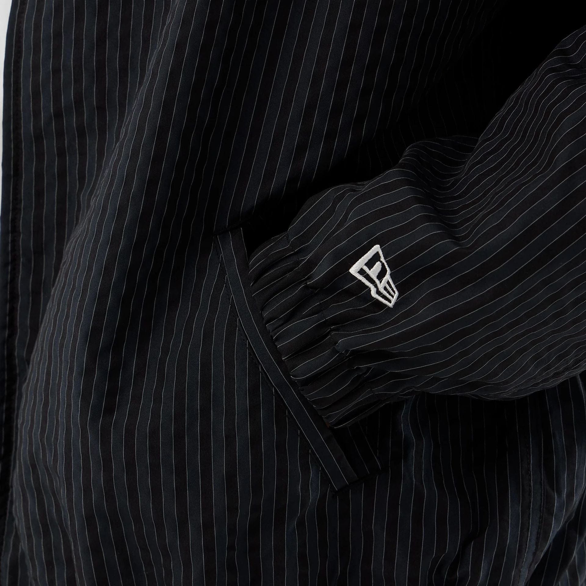 The model is wearing this New Era Street Class jacket in navy. 5