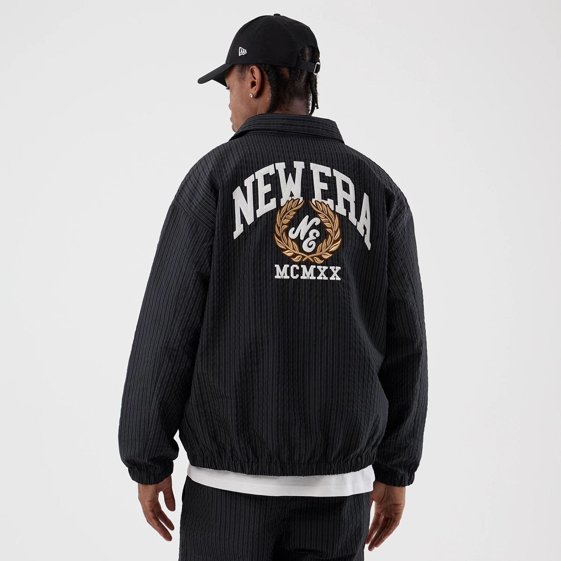 The model is wearing this New Era Street Class jacket in navy. 2