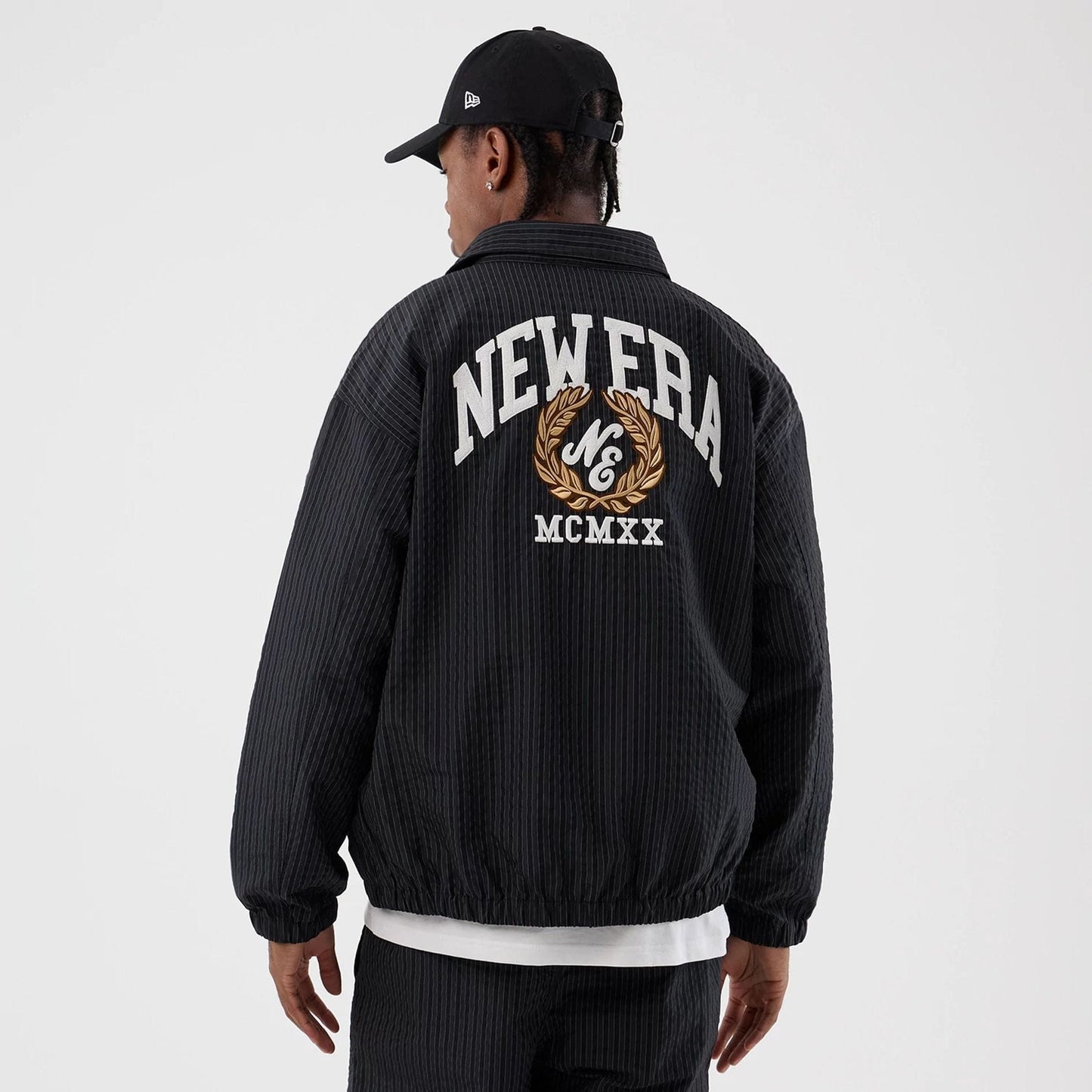 The model is wearing this New Era Street Class jacket in navy. 2
