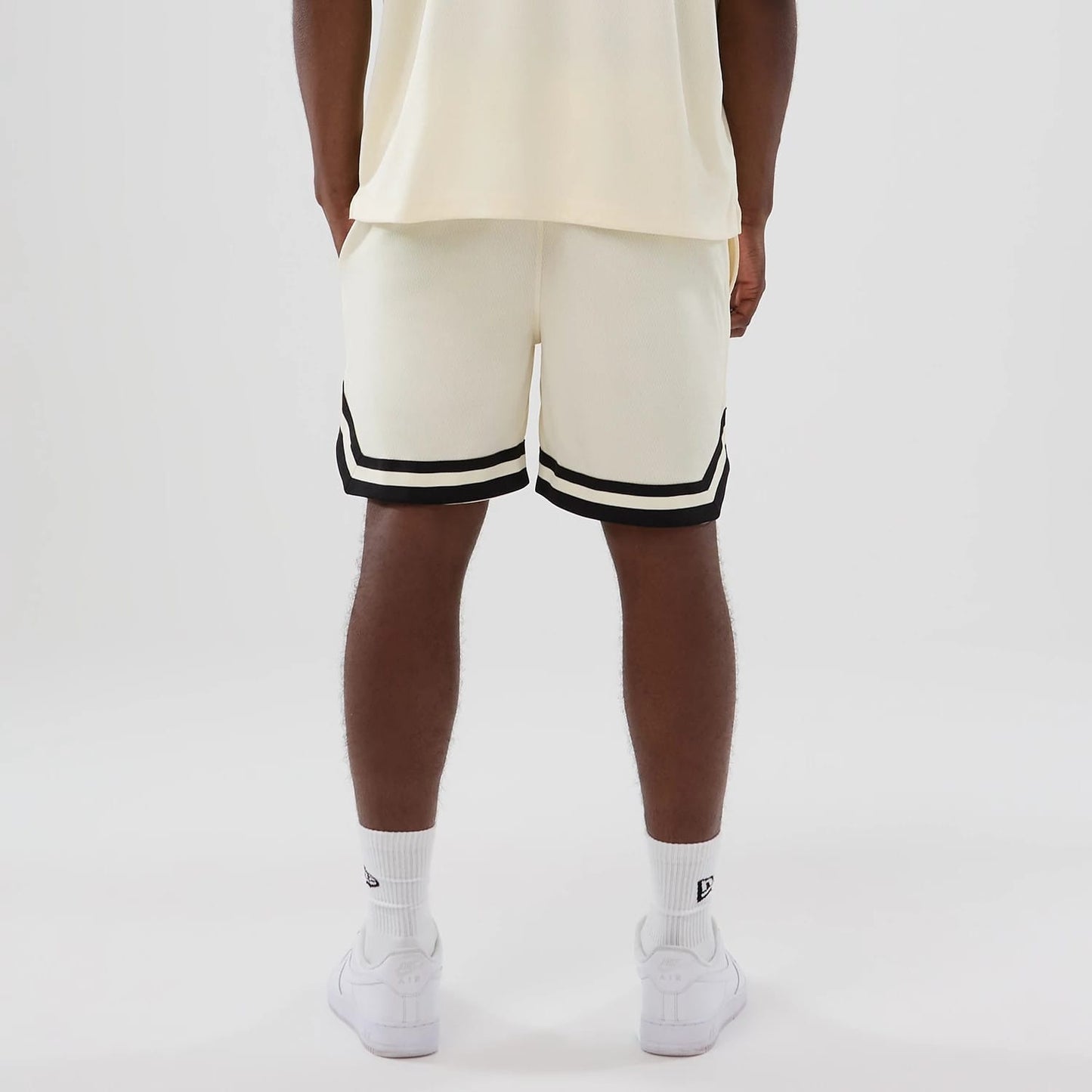 The model is wearing these NFL Historic Las Vegas Raiders shorts in cream. 2