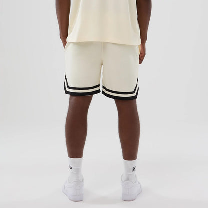 The model is wearing these NFL Historic Las Vegas Raiders shorts in cream. 2