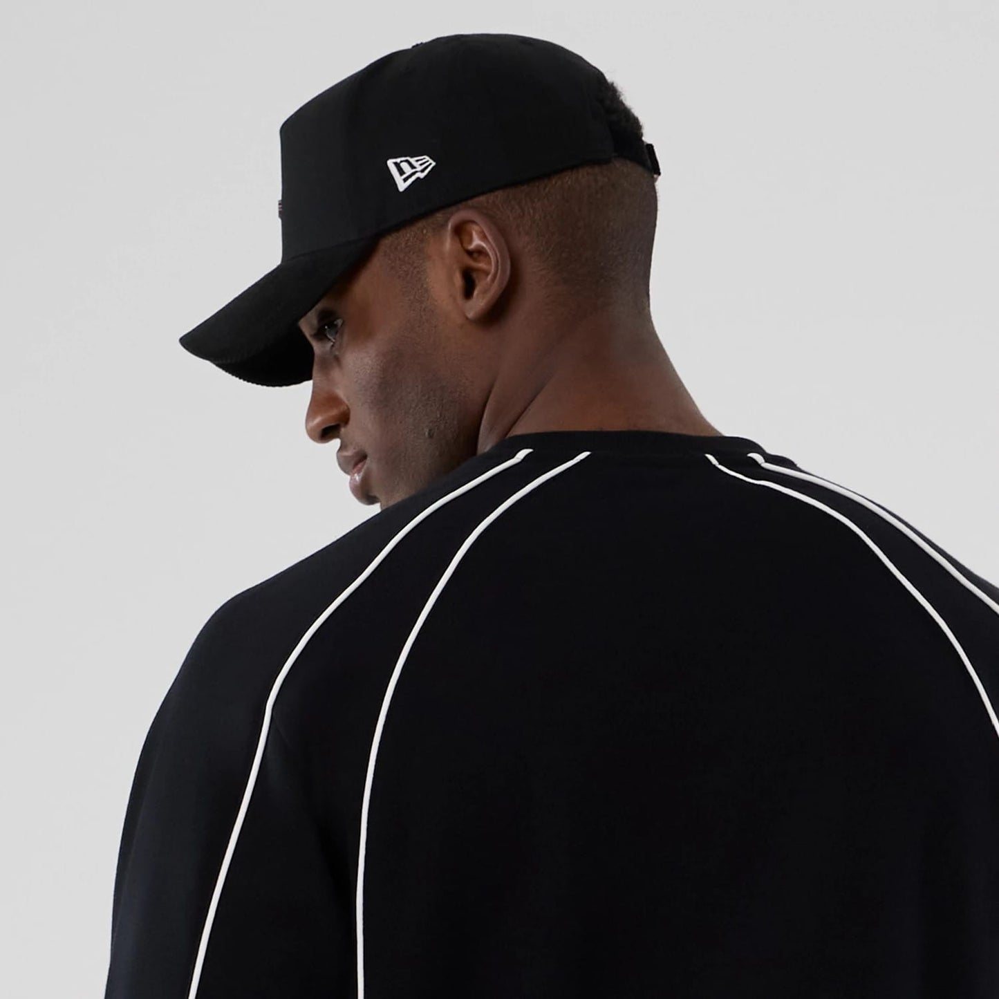 The Male model is wearing New Era Colour Block Black Crew Neck Sweater 6