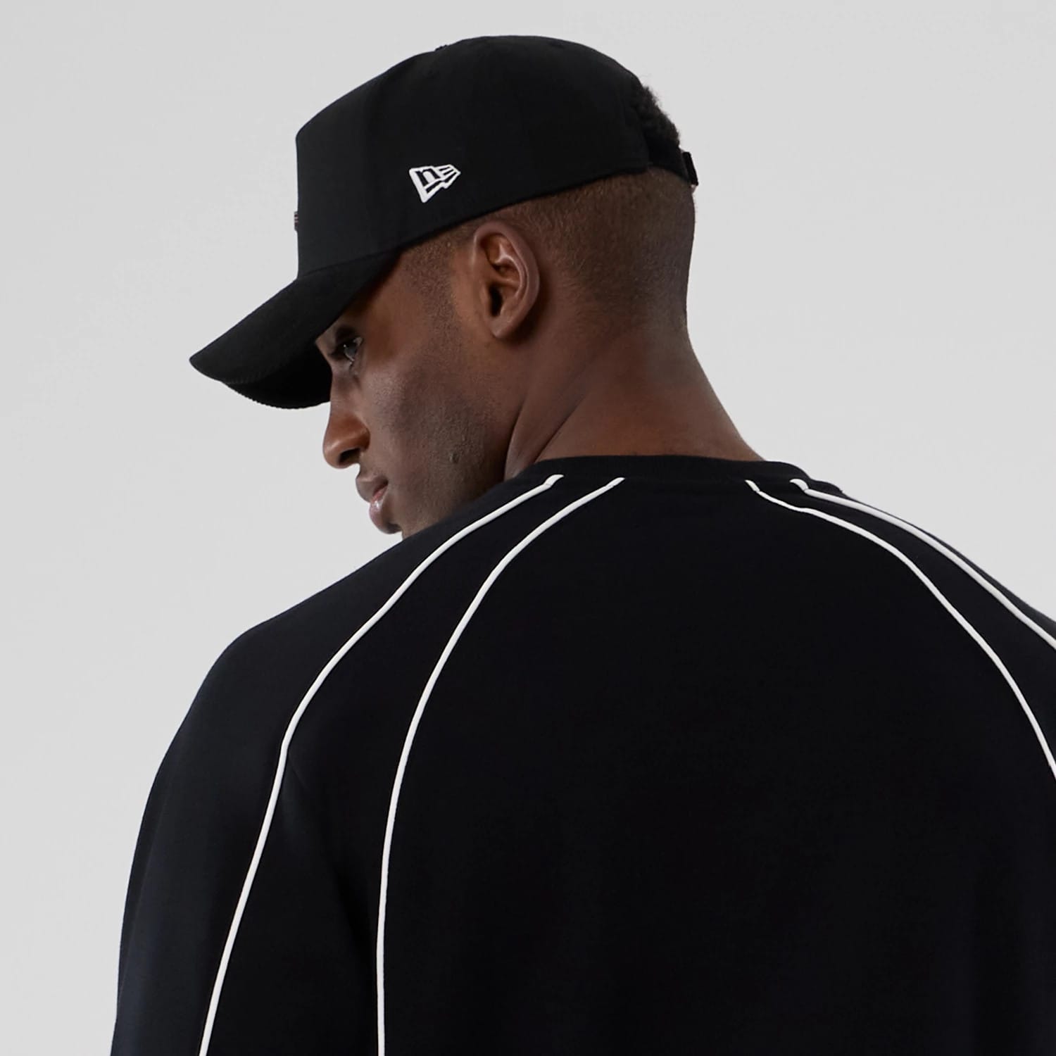 The Male model is wearing New Era Colour Block Black Crew Neck Sweater 6