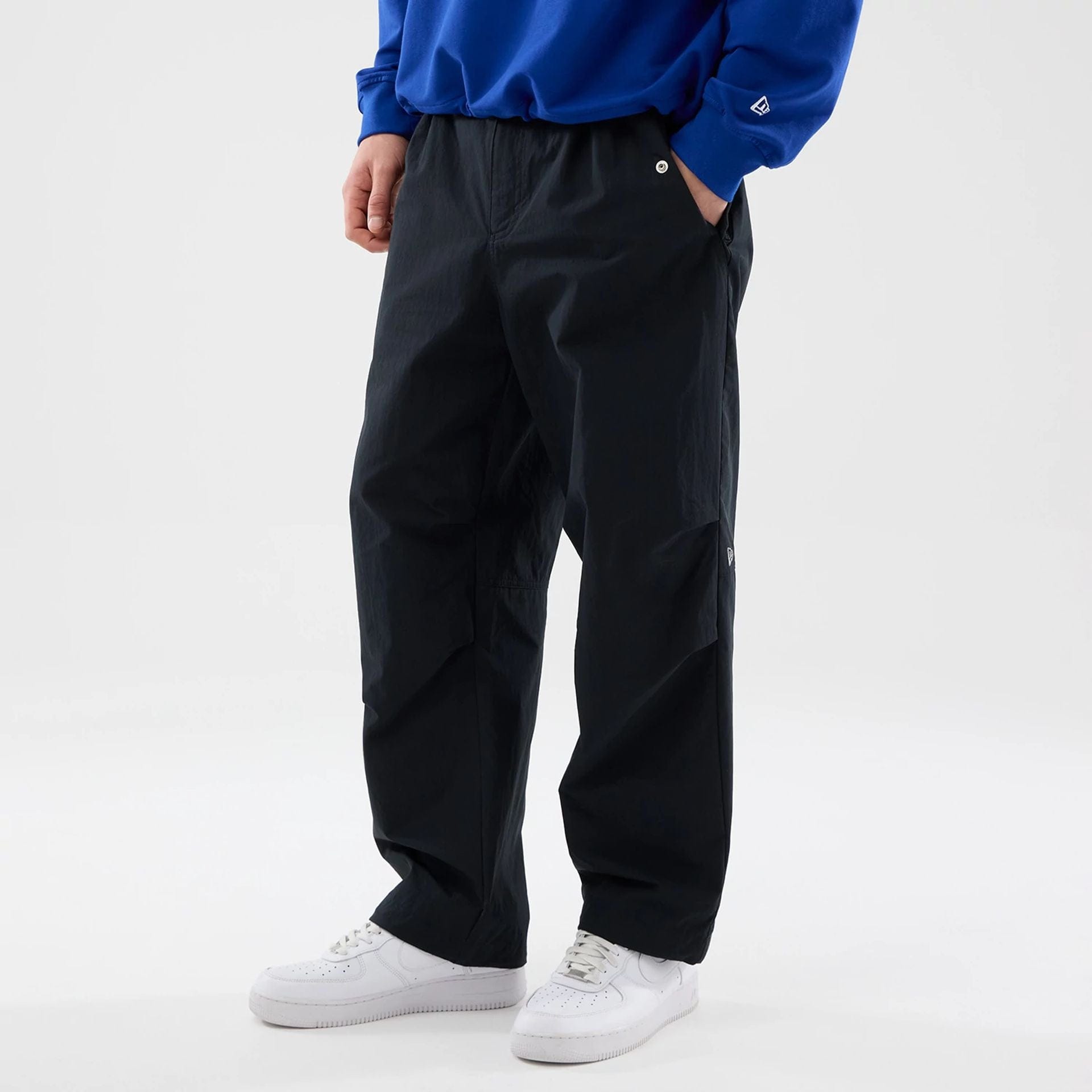 The Male model is wearing New Era Organic Black Parachute Trousers 6