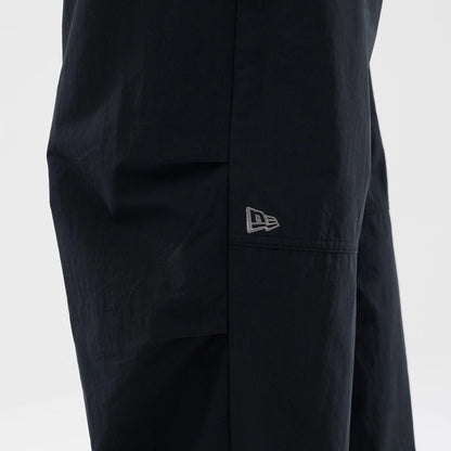 The Male model is wearing New Era Organic Black Parachute Trousers 4