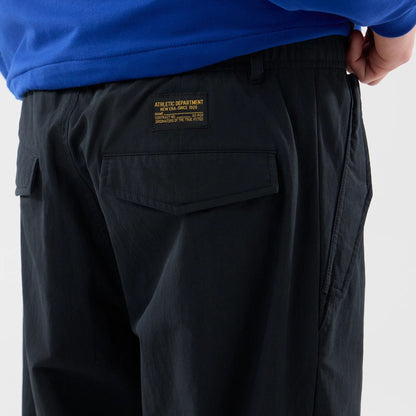 The Male model is wearing New Era Organic Black Parachute Trousers 5