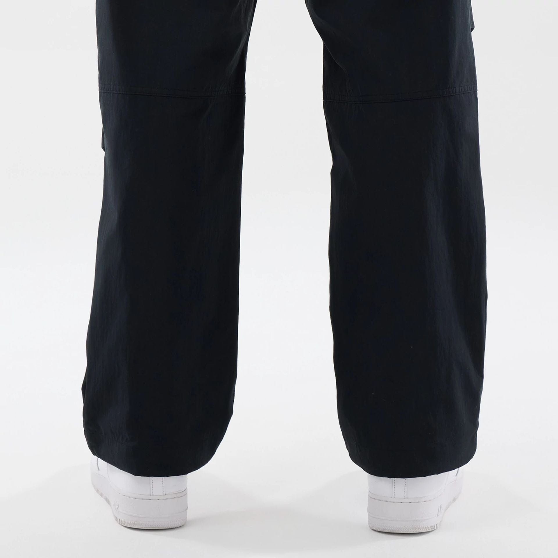 The Male model is wearing New Era Organic Black Parachute Trousers 7