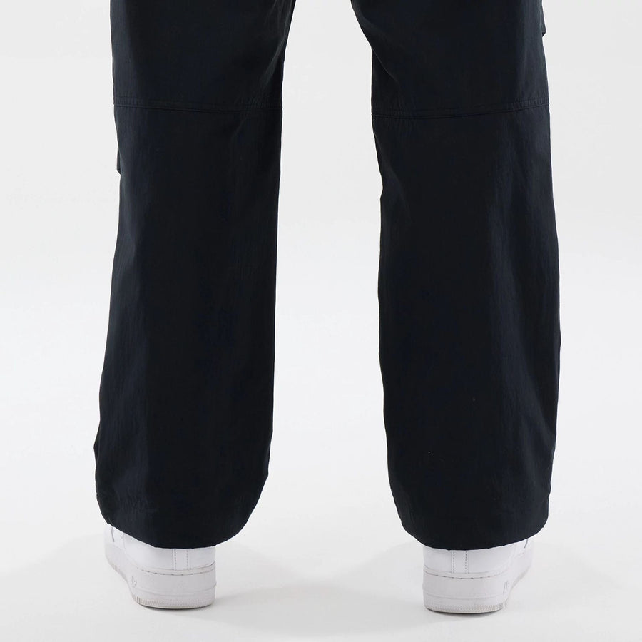 The Male model is wearing New Era Organic Black Parachute Trousers 7