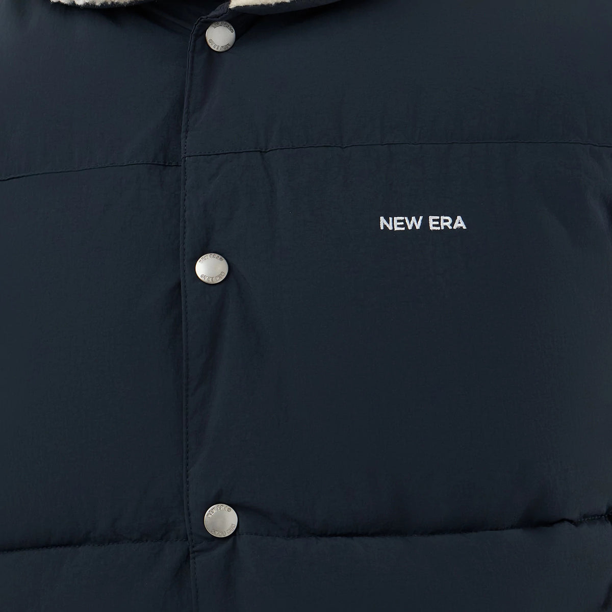 The Male model is wearing  New Era Organic Boa Neck Navy Gilet 6
