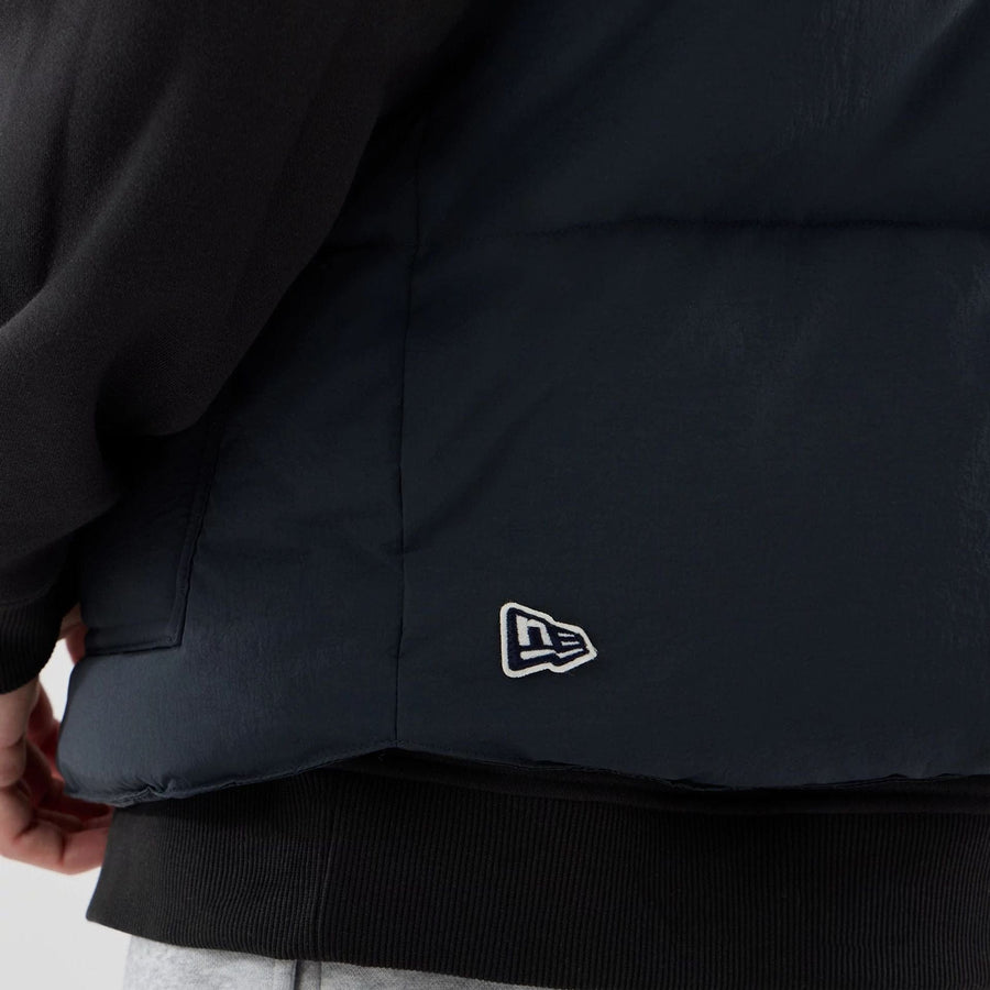 The Male model is wearing  New Era Organic Boa Neck Navy Gilet  7