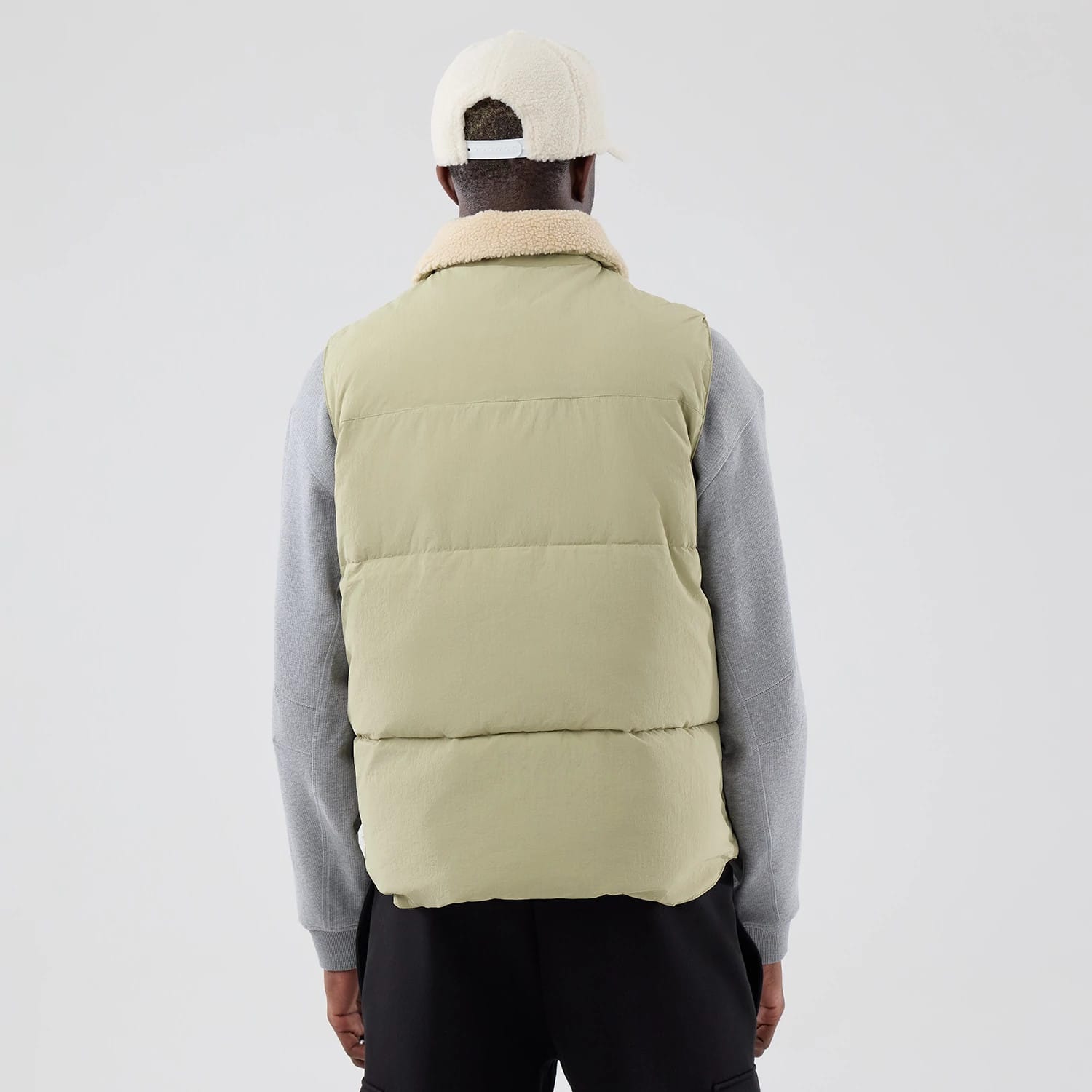The Male model is wearing  New Era Organic Boa Neck Khaki Gilet 2